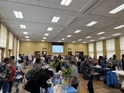 This image from the Spring Into Wellness event held on May 15 provides a wide view of the event floor, showing community members engaging with various health, wellness, and support organizations.