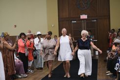 The Rock the Runway Fashion Show at the Raymond Jordan Senior Center showcased a lively community gathering featuring a full runway, an engaged audience, and a diverse lineup of participants presenting a wide range of unique outfits, from formal attire and coordinated sets to cultural garments and creative designs. Attendees filled the room, capturing moments on their devices and applauding each model who walked the runway, including individuals dressed in detailed patterns, bright colors, textured fabrics, accessories, and themed ensembles. The event included stage moments, presentations, and celebratory gestures, adding to its energetic atmosphere. Supported by the Springfield Department of Elder Affairs, the fashion show emphasized creativity, self‑expression, local engagement, and community pride, with in‑person registration and event details promoted through the official Rock the Runway flyer for July 11, 2025.