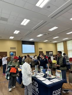 This image from the Spring Into Wellness event held on May 15 shows attendees learning about energy‑related assistance programs and available household support services.