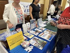 This image from the Spring Into Wellness event held on May 15 highlights a Food Bank table offering nutrition support information and regional food assistance program materials.
