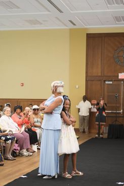 The Rock the Runway Fashion Show at the Raymond Jordan Senior Center showcased a lively community gathering featuring a full runway, an engaged audience, and a diverse lineup of participants presenting a wide range of unique outfits, from formal attire and coordinated sets to cultural garments and creative designs. Attendees filled the room, capturing moments on their devices and applauding each model who walked the runway, including individuals dressed in detailed patterns, bright colors, textured fabrics, accessories, and themed ensembles. The event included stage moments, presentations, and celebratory gestures, adding to its energetic atmosphere. Supported by the Springfield Department of Elder Affairs, the fashion show emphasized creativity, self‑expression, local engagement, and community pride, with in‑person registration and event details promoted through the official Rock the Runway flyer for July 11, 2025.