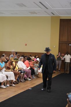 The Rock the Runway Fashion Show at the Raymond Jordan Senior Center showcased a lively community gathering featuring a full runway, an engaged audience, and a diverse lineup of participants presenting a wide range of unique outfits, from formal attire and coordinated sets to cultural garments and creative designs. Attendees filled the room, capturing moments on their devices and applauding each model who walked the runway, including individuals dressed in detailed patterns, bright colors, textured fabrics, accessories, and themed ensembles. The event included stage moments, presentations, and celebratory gestures, adding to its energetic atmosphere. Supported by the Springfield Department of Elder Affairs, the fashion show emphasized creativity, self‑expression, local engagement, and community pride, with in‑person registration and event details promoted through the official Rock the Runway flyer for July 11, 2025.