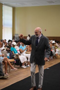 The Rock the Runway Fashion Show at the Raymond Jordan Senior Center showcased a lively community gathering featuring a full runway, an engaged audience, and a diverse lineup of participants presenting a wide range of unique outfits, from formal attire and coordinated sets to cultural garments and creative designs. Attendees filled the room, capturing moments on their devices and applauding each model who walked the runway, including individuals dressed in detailed patterns, bright colors, textured fabrics, accessories, and themed ensembles. The event included stage moments, presentations, and celebratory gestures, adding to its energetic atmosphere. Supported by the Springfield Department of Elder Affairs, the fashion show emphasized creativity, self‑expression, local engagement, and community pride, with in‑person registration and event details promoted through the official Rock the Runway flyer for July 11, 2025.