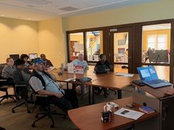 Photo of a computer class in Room 109 taught by instructor Diomaris Gomez, showing participants seated at tables during a lesson on confident internet browsing held on April 14 at 11 p.m., with desktop computers visible around the room.